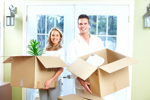 Professional movers carrying furniture in Queensway