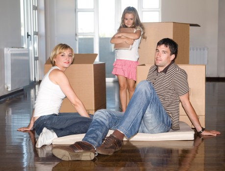 Professional movers navigating a busy Queensway street during an urgent relocation