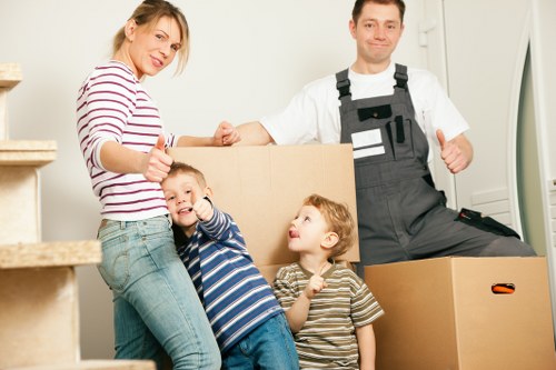 Packed office boxes and labelled workstation items for a Queensway move